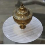 A Victorian gilt brass ink well with onyx base, diam. 14cm.
