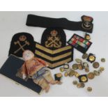 A quantity of naval badges and buttons, together with a cigarette case and a doll.