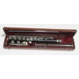 A nickel mounted rosewood flute by Mollenhauer & So, number 18992, fitted in leather case.
