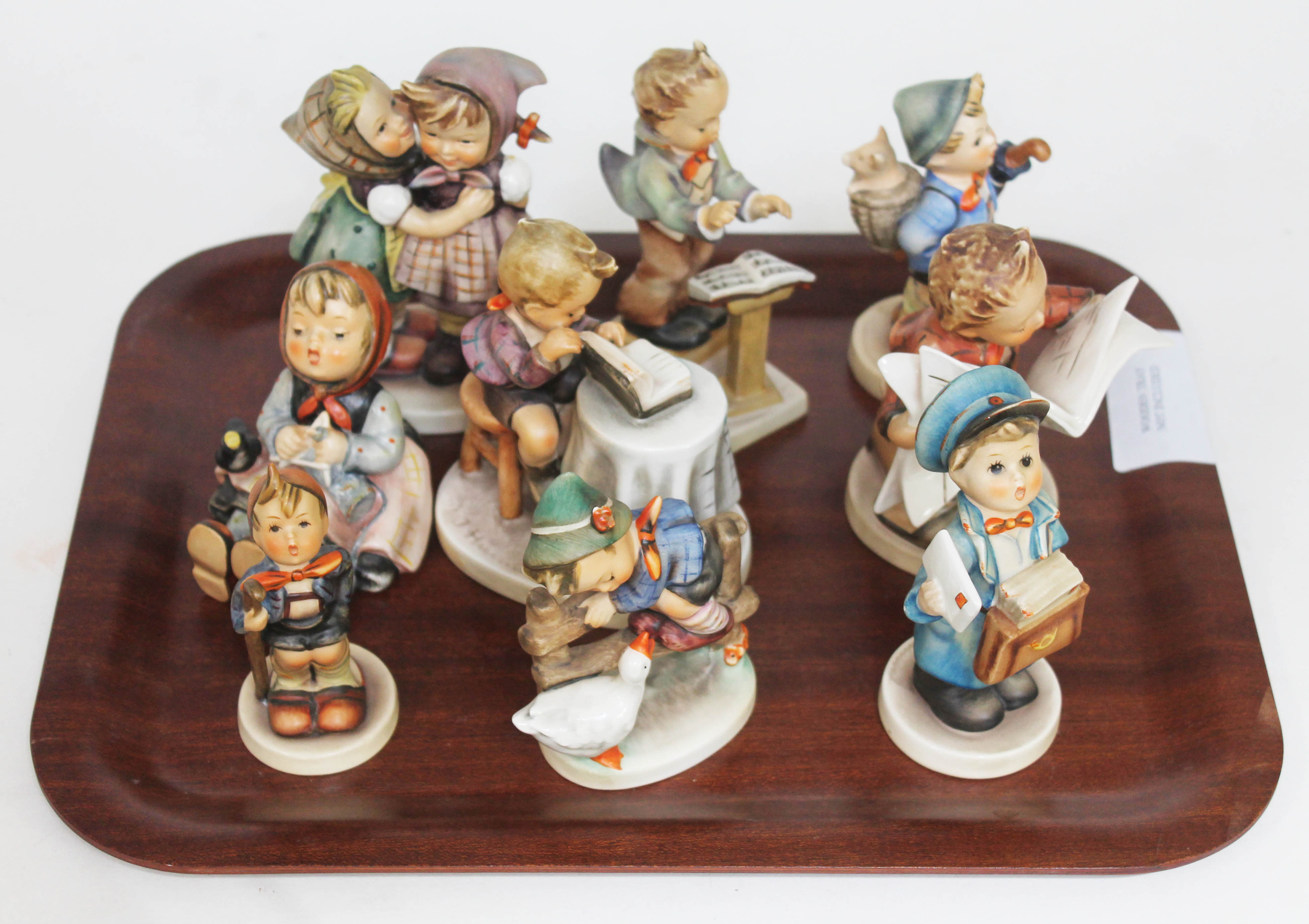 A group of nine Hummel figures.