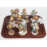 A group of nine Hummel figures.