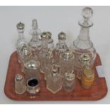 A quantity of mainly silver topped cruet bottles, a Georgian glass decanter etc.