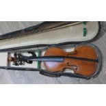 A group of eight violins, various sizes, with boxes.