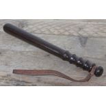 A teak police truncheon with leather strap stamped 'Padmore & Son Birmingham', length 40.5cm.