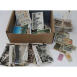 A box of mainly postcards, also including world banknotes and tickets.