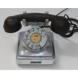 A vintage chrome Bell telephone with bakelite handset.