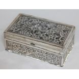 An eastern white metal box decorated with birds amongst flowering trees, unmarked, length 14.5cm.
