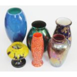A group of glass vases and a gilt pottery vase.