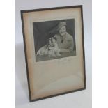 A mounted and framed photograph depicting a woman and dog, signed in pencil, image 18cm x 15cm,