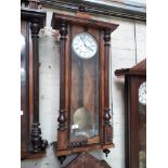 A weight driven walnut Vienna wall clock.