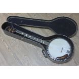 A Harmony five string banjo and hard case.