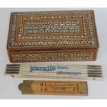 A bone inlaid box and two vintage rulers.