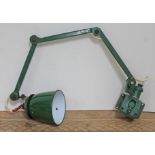 A green enamel industrial wall mounting anglepoise lamp.