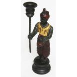 An eastern cast metal figural candlestick, height 29cm.