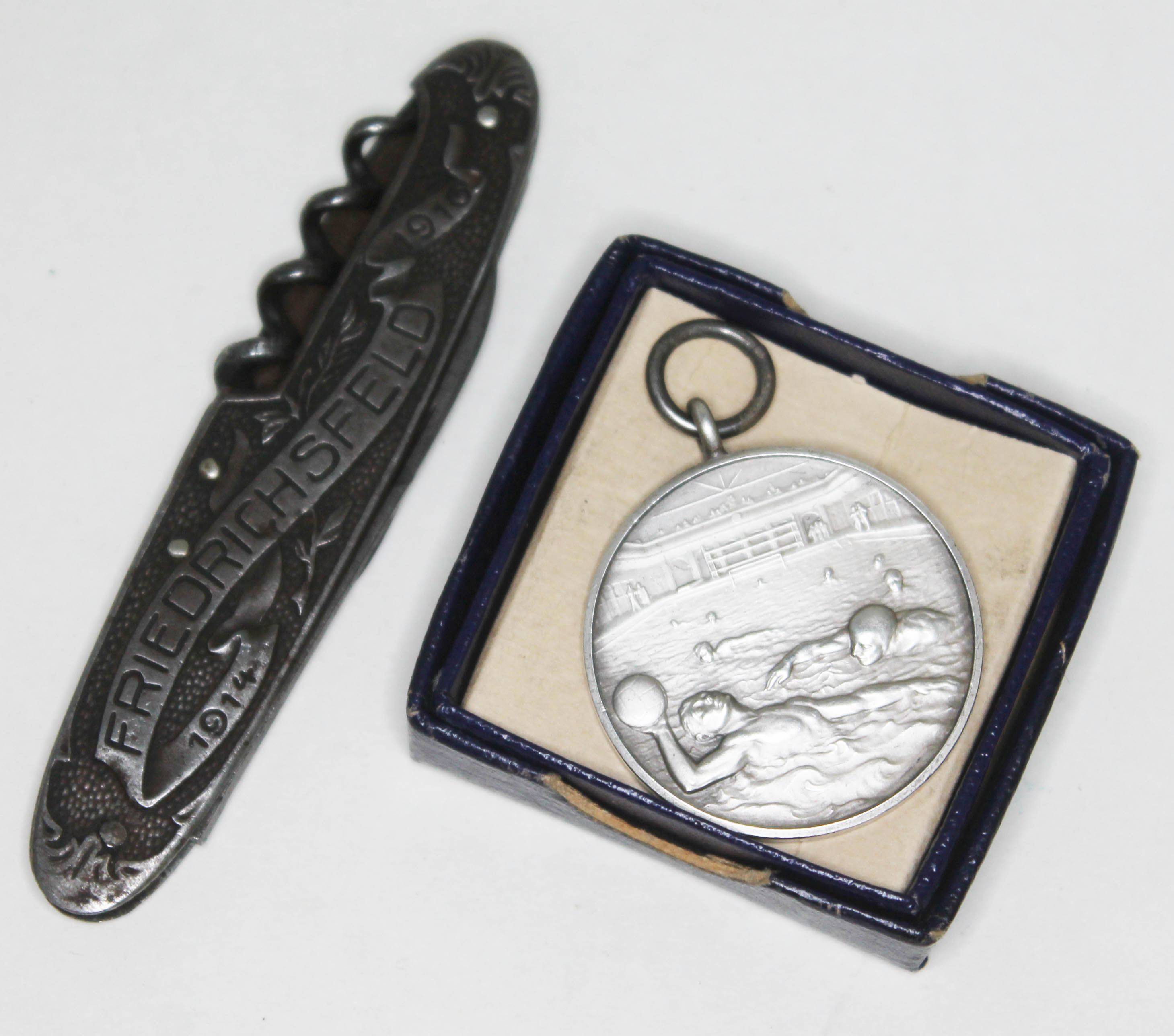 A water polo medal 1953 and a WWI Prisoner of War 'Souvenir De Captivite penknife'.