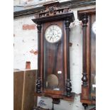 A weight driven walnut Vienna wall clock.