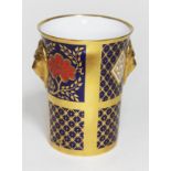 A Crown Derby style beaker with lion masks by Caverswall, height 11.5cm.