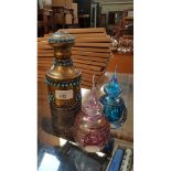 Brass and white metal Indian bottle, decorated with stones and 2 iridescent bottles.