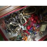 A red box of mixed costume jewellery