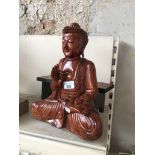 A wooden Buddha with stand