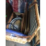 A wicker picnic hamper basket with items including pictures, clock, shower head, Denby, etc