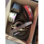 A box with vintage tins and brassware