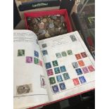 A box containing coins and stamp albums