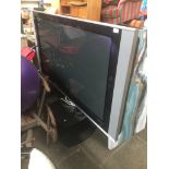 A Hitachi 55" flat screen tv on stand