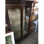A mahogany bow front glazed display cabinet