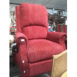 A red upholstered electric reclining armchair