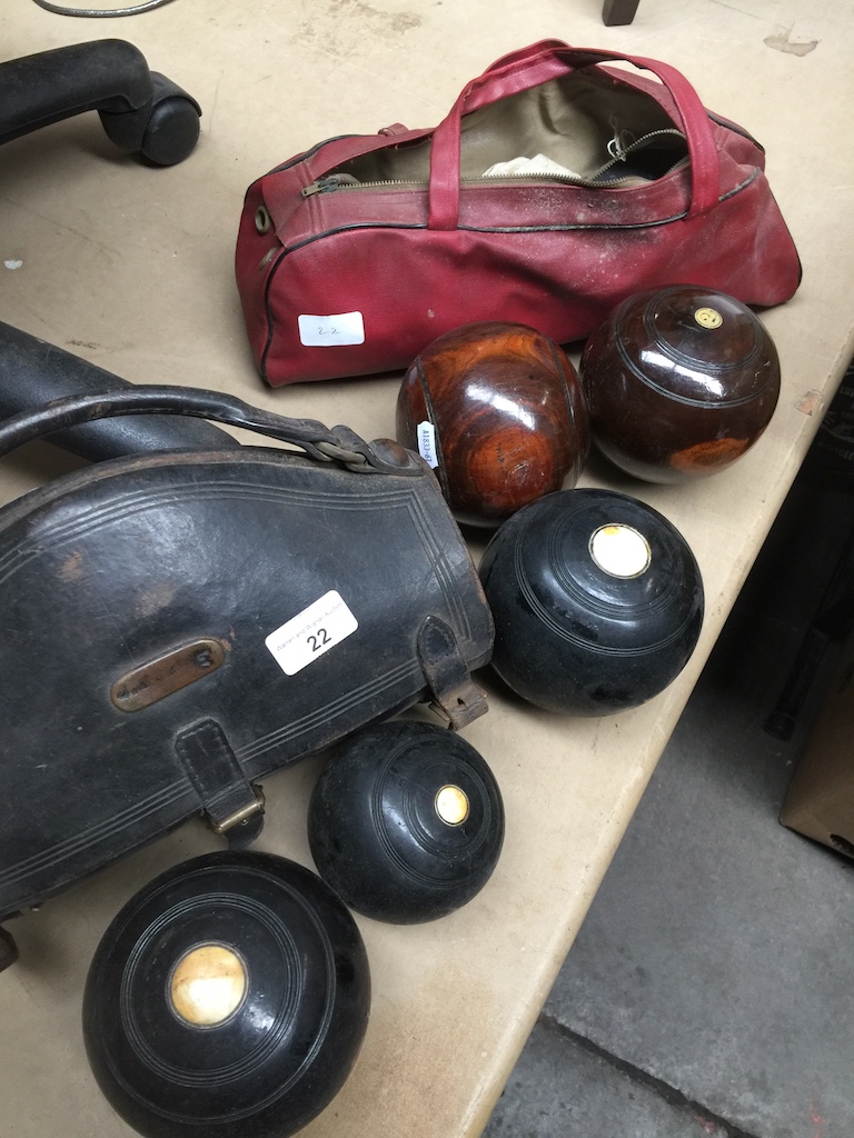 Two sets of crown green bowls