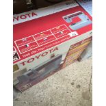 A boxed Toyota electric sewing machine.