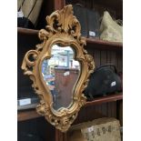 A gilt frame plaster mirror