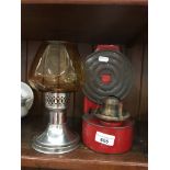 A Mason candle lamp and another small oil lamp