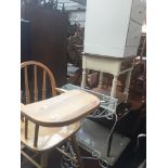 A wrought metal and glass table, a wooden high chair and a 2 drawer cabinet and a desk stand