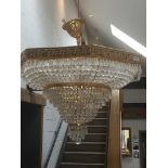 A modern gilt metal and glass chandelier