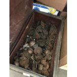 A tin trunk containing large quantity of vintage castors, furniture handles, etc.