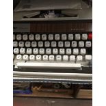 A Brother DeLuxe 1300 typewriter with instructions and extra ribbons in case.