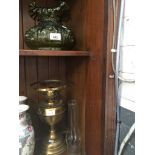 A brass oil lamp with pressed green glass shade.