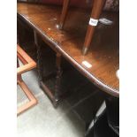 An oak drop leaf table with twist legs