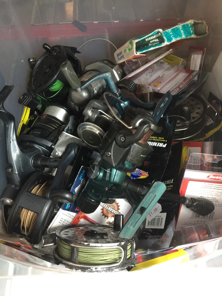 A box of fishing reels and tackle