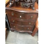 A mahogany reproduction serpentine front three drawer chest