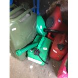 Four plastic petrol/diesel jerry cans and a metal petrol jerry can