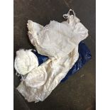 A bag of christening gowns, bonnets, etc.