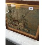 A 19th century tapestry picture depicting a farm with figures and animals, mounted and laid on