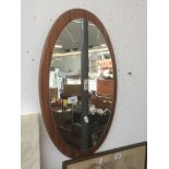 A retro teak framed mirror