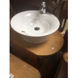 A bathroom vanity unit with basin and taps