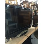 A Hitachi 26" LCD TV with built in DVD player and remote