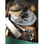 A box of mainly cutlery and large platters.