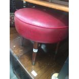 A retro red rexene top stool with tapered legs